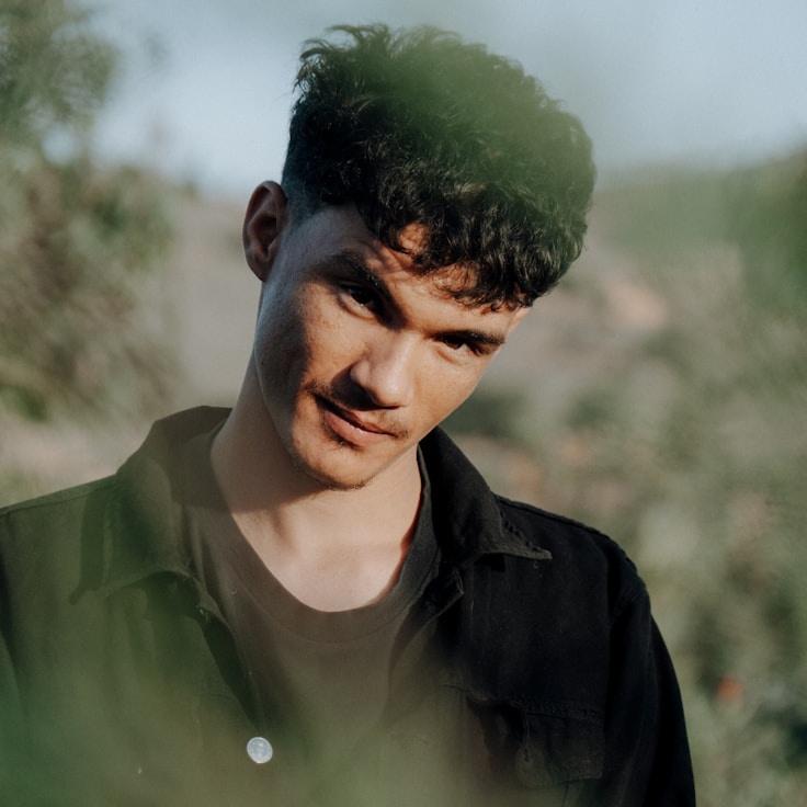 Alex Kim, Lead Design Curator at Prime Harbor Hub, reviewing corporate floral arrangements